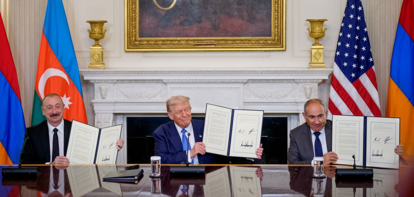 U.S. President Donald Trump (center), Azerbaijani President Ilham Aliyev (left) and Armenian Prime Minister Nikol Pashinyan (right) hold up an agreement signed during a ceremony at the White House on Aug. 8, 2025.
