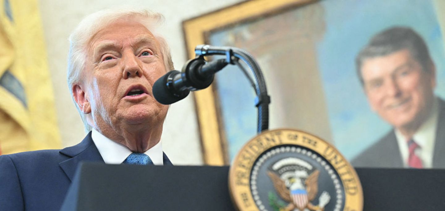 A portrait of former U.S. President Ronald Reagan is seen in the background as U.S. President Donald Trump speaks to reporters in the Oval Office of the White House in Washington, D.C., on April 22, 2025.