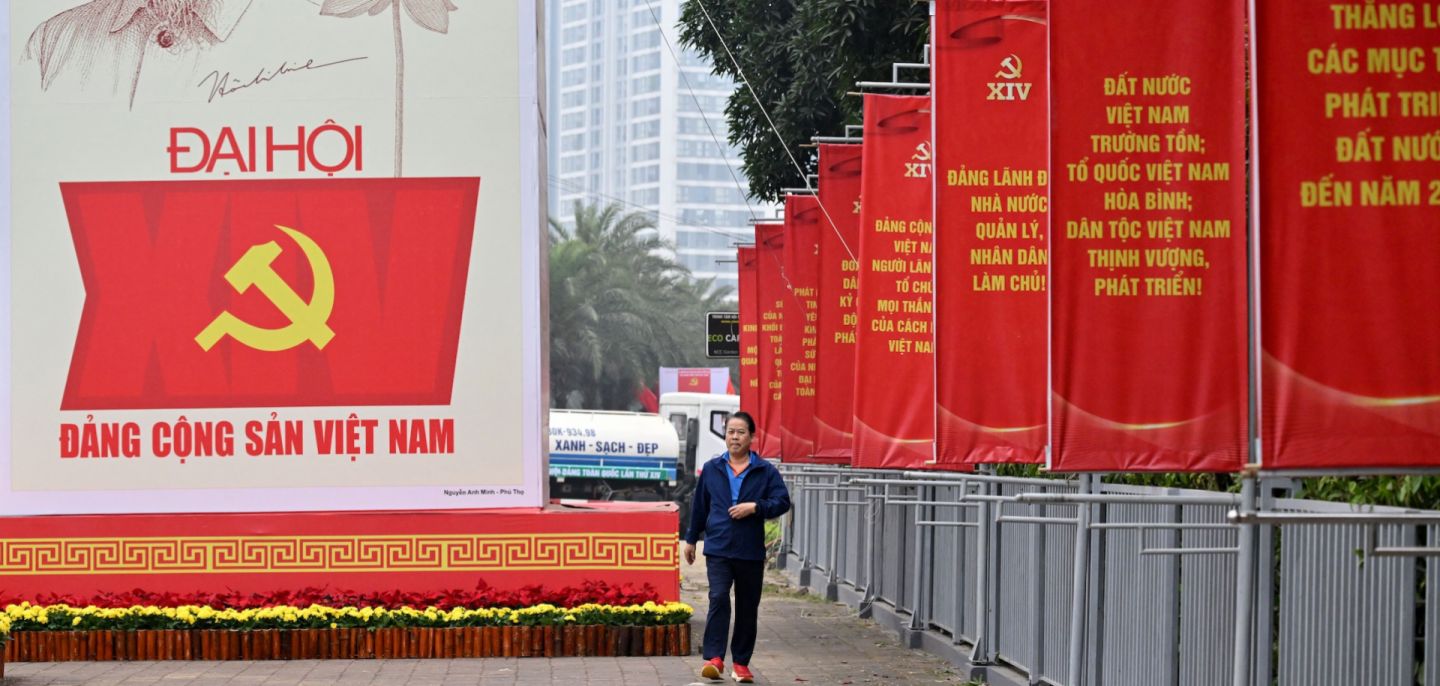 A man walks past a billboard for the 14th Congress of the Communist Party of Vietnam outside the National Convention Center in Hanoi on Jan. 15, 2026. 