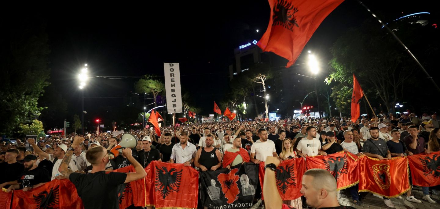 Protestors hold national flags as they gather outside Albania's prime minister's office to oppose the construction of luxury resorts, in Tirana on June 25. Protestors hold national flags as they gather outside Albania's prime minister's office to oppose the construction of luxury resorts, in Tirana on June 25.Protestors hold national flags as they gather outside Albania's prime minister's office to oppose the construction of luxury resorts, in Tirana on June 25.