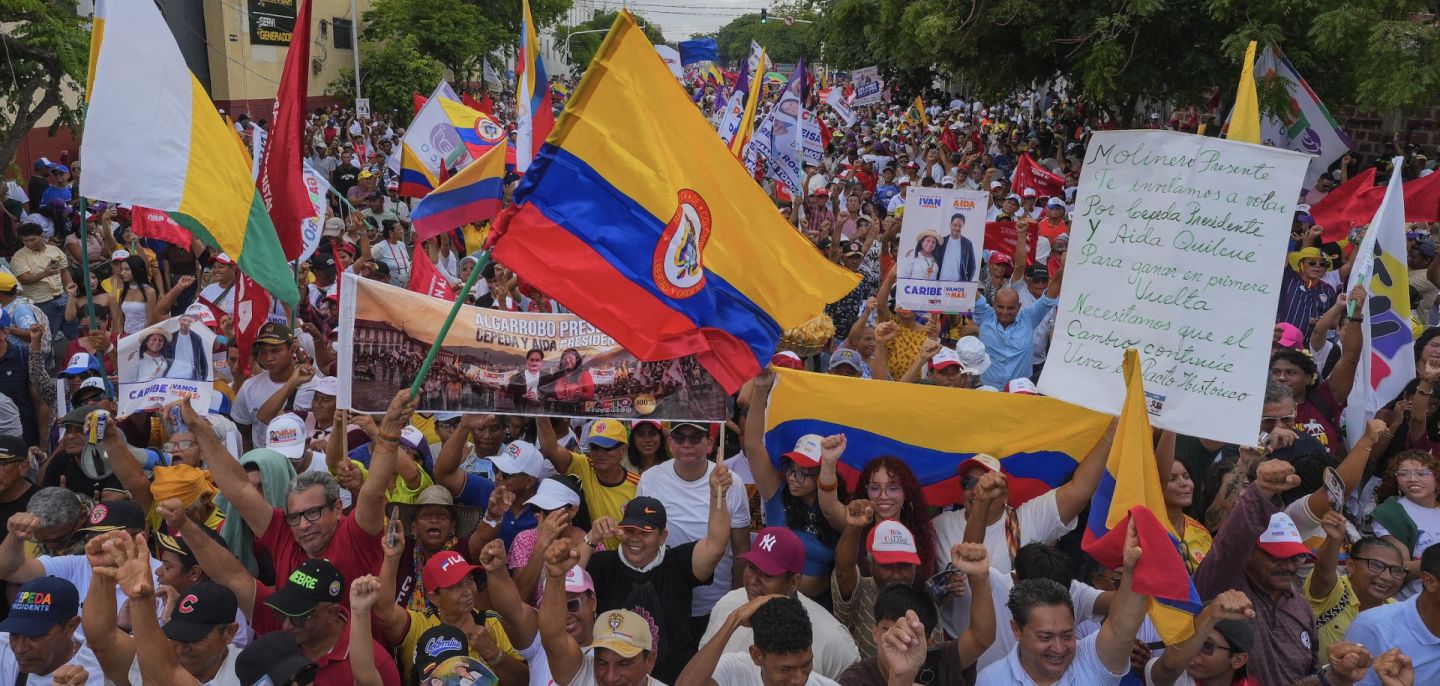 Supporters of Colombian presidential candidate Ivan Cepeda wave flags ahead of his closing campaign rally in Barranquilla, Colombia, on May 24, 2026.