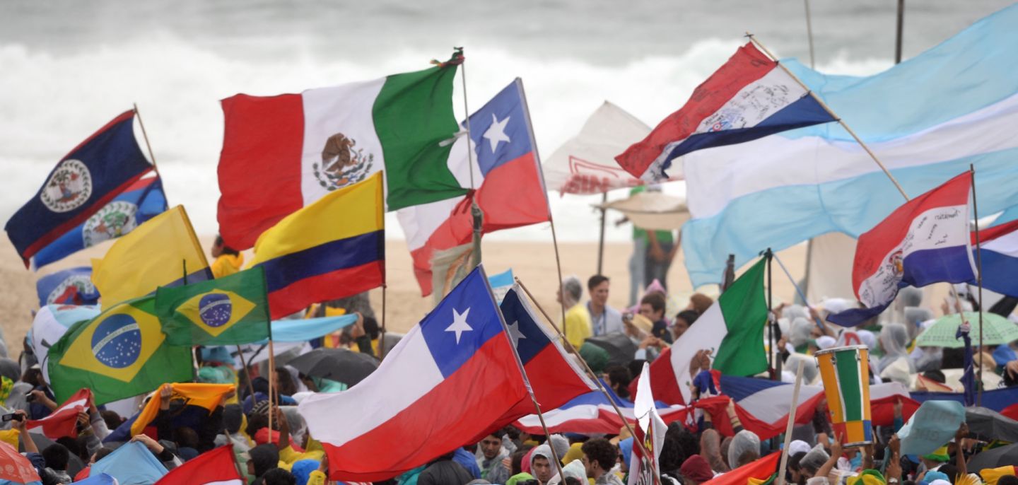 Pilgrims with flags from different countries gather at Copacabana beach in Rio de Janeiro, Brazil, on July 23, 2013, as they wait for the official opening of the Catholic Church's World Youth Day, which will be celebrated with a holy Mass. 