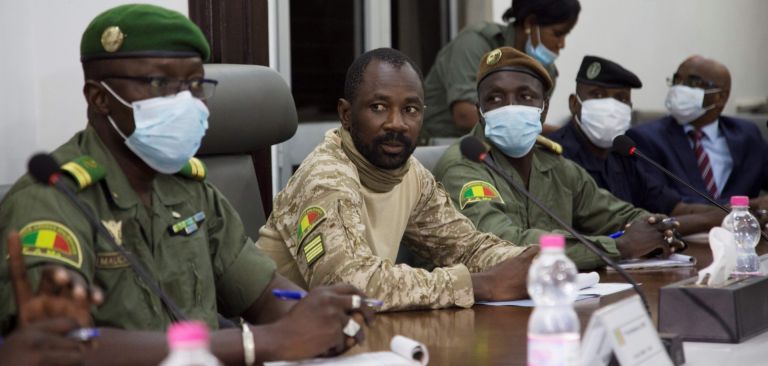 Colonel Assimi Goita (center) sits between other Malian military leaders during a meeting with an Economic Community of West African States (ECOWAS) delegation on Aug. 22, 2020. Goita seized power for the second time in a May 2021 coup. Colonel Assimi Goita (center) sits between other Malian military leaders during a meeting with an Economic Community of West African States (ECOWAS) delegation on Aug. 22, 2020. Goita seized power for the second time in a May 2021 coup.