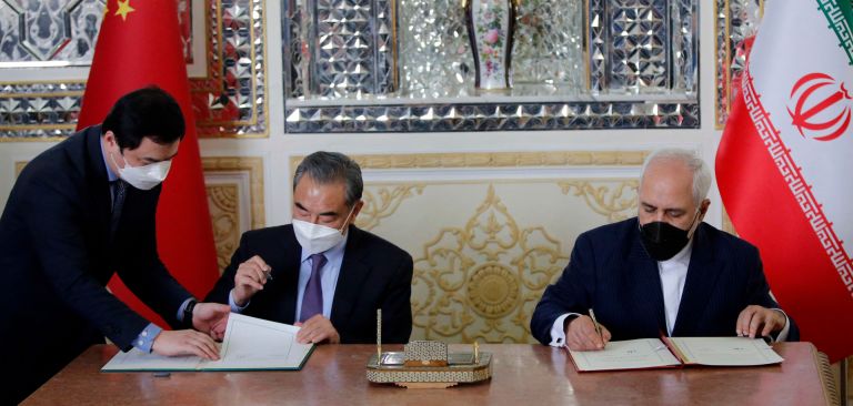 Iran and China’s foreign ministers (right to left) sign a partnership agreement in Tehran on March 27, 2021. Iran and China’s foreign ministers (right to left) sign a partnership agreement in Tehran on March 27, 2021.