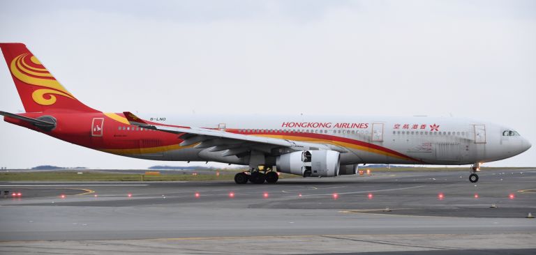 A Hong Kong Airlines plane lands Sept. 1, 2021, at Sydney Kingsford Smith Airport. Hong Kong authorities will suspend transit flights from 150 countries from Jan. 16 to Feb. 15 in response to the global spread of the omicron variant. A Hong Kong Airlines plane lands Sept. 1, 2021, at Sydney Kingsford Smith Airport.