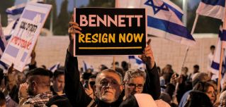 A man holds up a sign during an anti-government protest staged by Israeli right-wing supporters in Jerusalem, Israel, on April 6, 2022. 