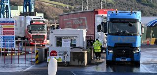 Trucks carrying goods are checked upon arriving at the port in Larne, Northern Ireland, on Jan. 17, 2023.