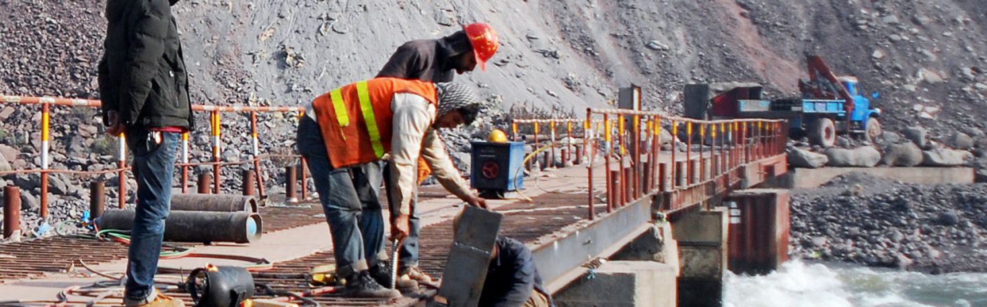 A Chinese engineer supervises workers building a bridge over a river near Muzaffarabad, the capital of Pakistani-administered Kashmir. A Chinese engineer supervises workers building a bridge over a river near Muzaffarabad, the capital of Pakistani-administered Kashmir.