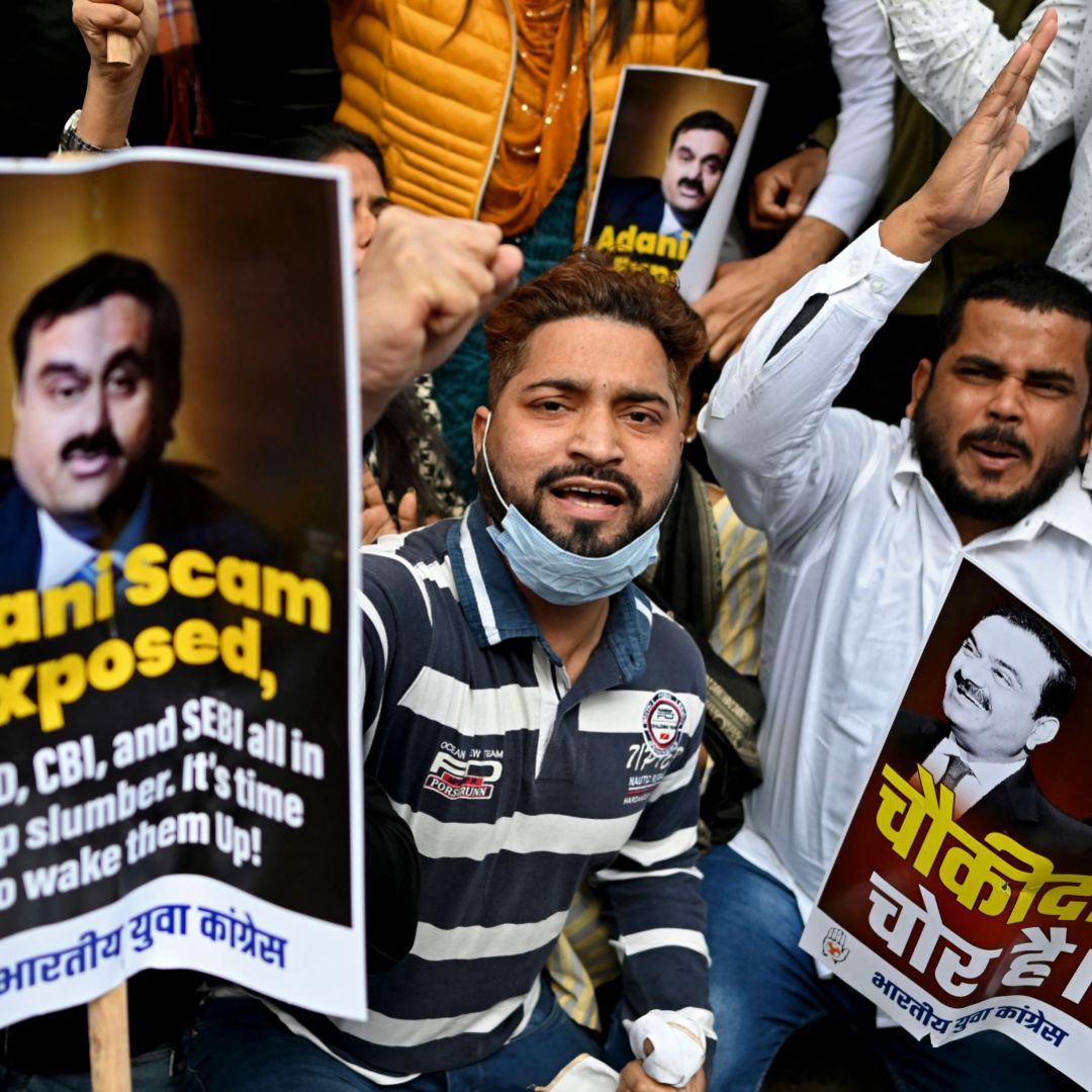 Activists who are part of the youth wing of the opposition Indian National Congress party hold placards and shout slogans during a protest outside the regional headquarters of India's Life Insurance Corporation in New Delhi, India, on Feb. 7, 2023. The protesters are calling for an inquiry into allegations of major accounting fraud at the Adani Group.