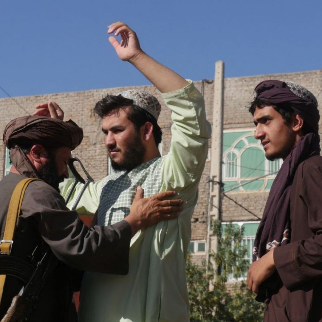 A Taliban fighter (L) frisks men at a checkpoint after a blast during Friday prayers Sept. 2, 2022, in Gazargah mosque in Herat. Foreign states' limited abilities to counter terrorist groups in Afghanistan may allow the extremist threat there to swell again. A Taliban fighter (L) frisks men at a checkpoint after a blast during Friday prayers Sept. 2, 2022, in Gazargah mosque in Herat.