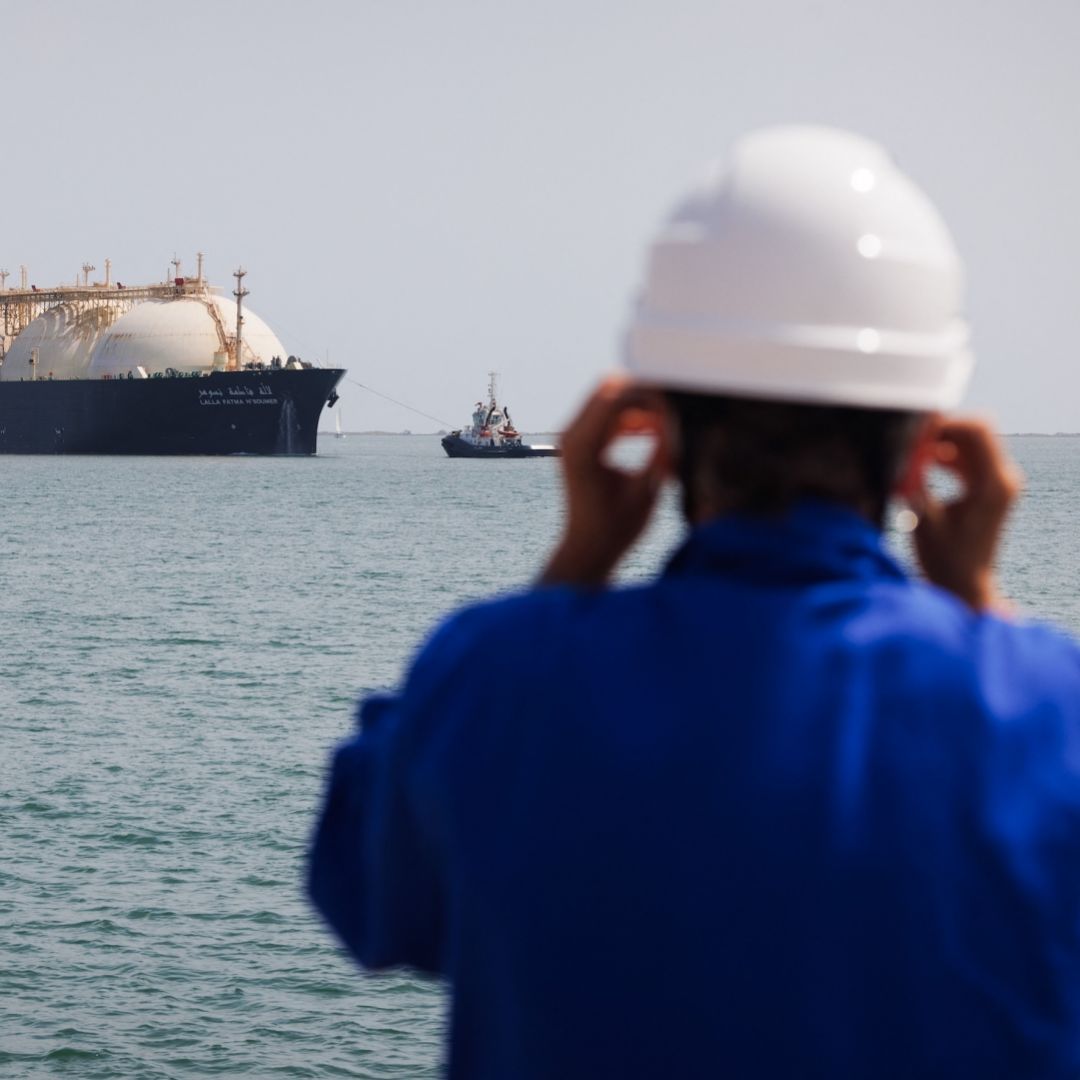 A worker stands on the uploading dock of Cavaou LNG terminal in Fos-sur-Mer, France, on June 22, 2023, while the tanker boat "Lalla Fatma N'Soumer" arrives full of LNG ready to be delivered. 