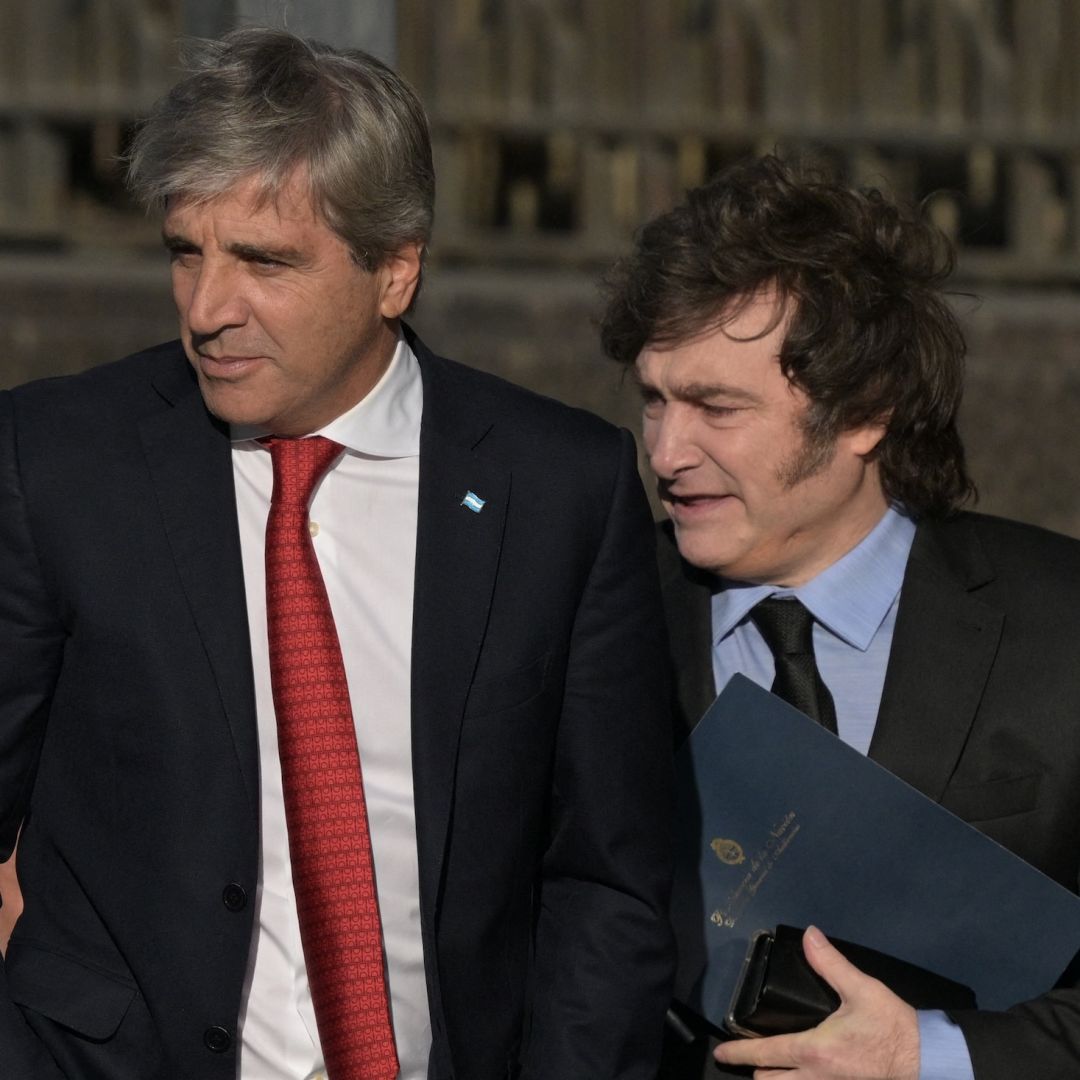 Argentina's economy minister Luis Caputo (L) and Argentine President Javier Milei walk from the Casa Rosada Presidential Palace after a meeting on April 14, 2025.