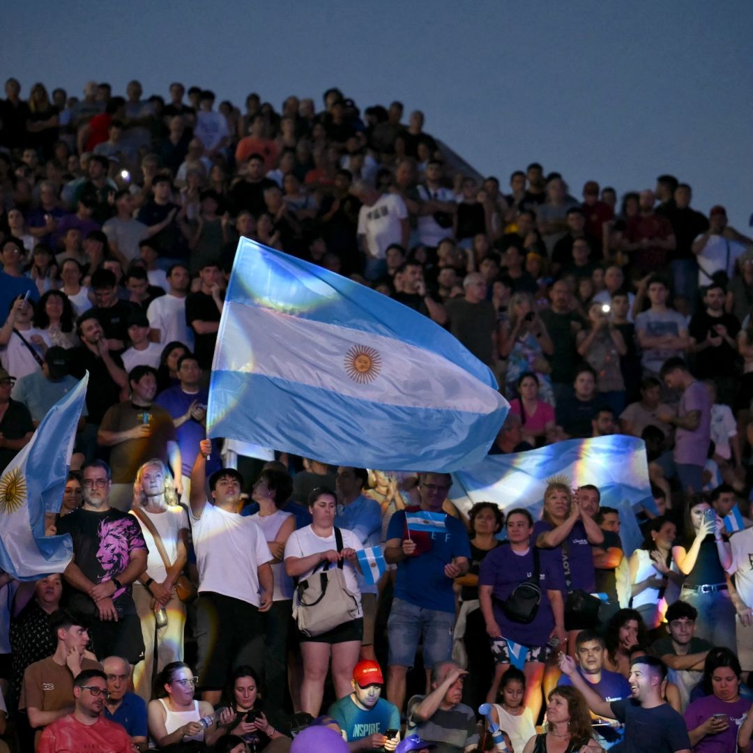 Supporters of Argentine President Javier Milei's Liberty Advances (LLA) party wave flags during a campaign rally in Rosario, Argentina, on Oct. 23, 2025. Supporters of Argentine President Javier Milei's Liberty Advances (LLA) party wave flags during a campaign rally in Rosario, Argentina, on Oct. 23, 2025.