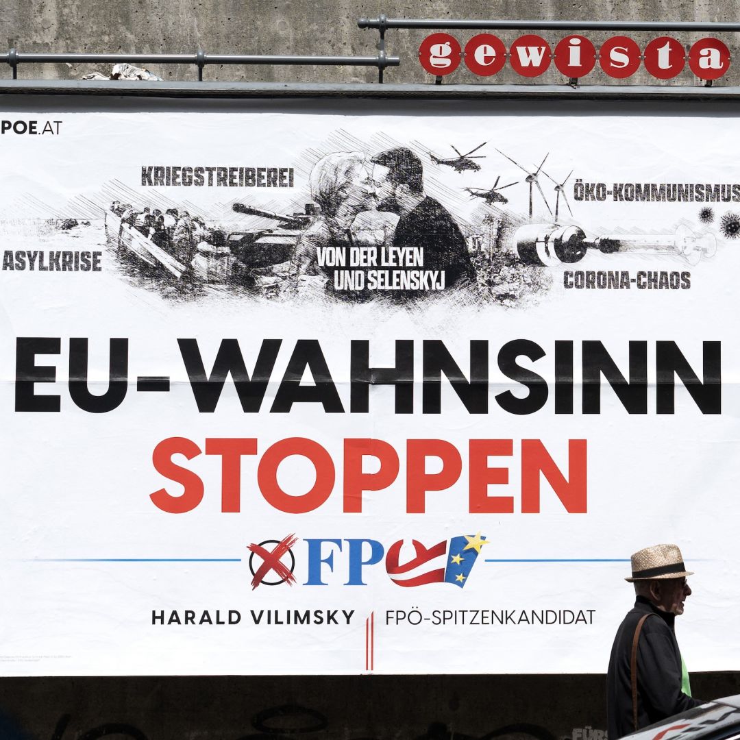 A pedestrian walks past a billboard with an election poster for Harald Vilimsky, the top candidate of Austria's right-wing Freedom Party in the June European Parliament elections, on May 13, 2024. 