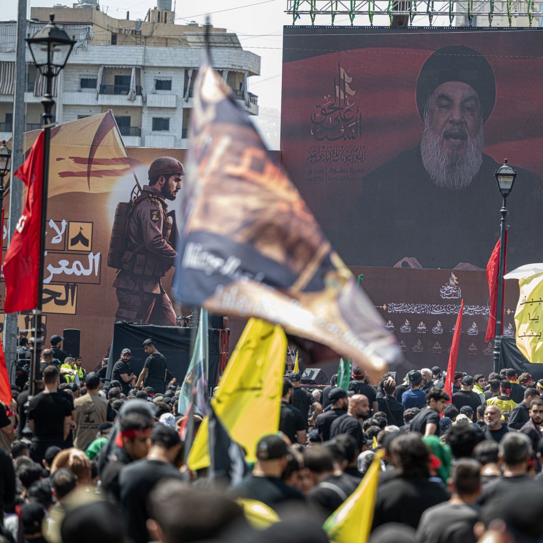 People watch a televised speech of Lebanon's Hezbollah chief Hasan Nasrallah commemorating the seventh-century killing of the Prophet Muhammad's grandson Imam Hussein, in Beirut, Lebanon, on July 17, 2024.