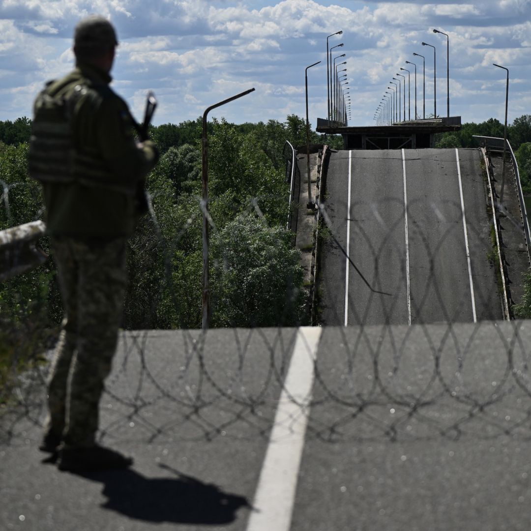 An officer of the State Border Guard Service of Ukraine stands on a destroyed bridge over the Dnipro River, which forms the state border between Ukraine and Belarus, on June 1, 2026. An officer of the State Border Guard Service of Ukraine stands on a destroyed bridge over the Dnipro River, which forms the state border between Ukraine and Belarus, on June 1, 2026.