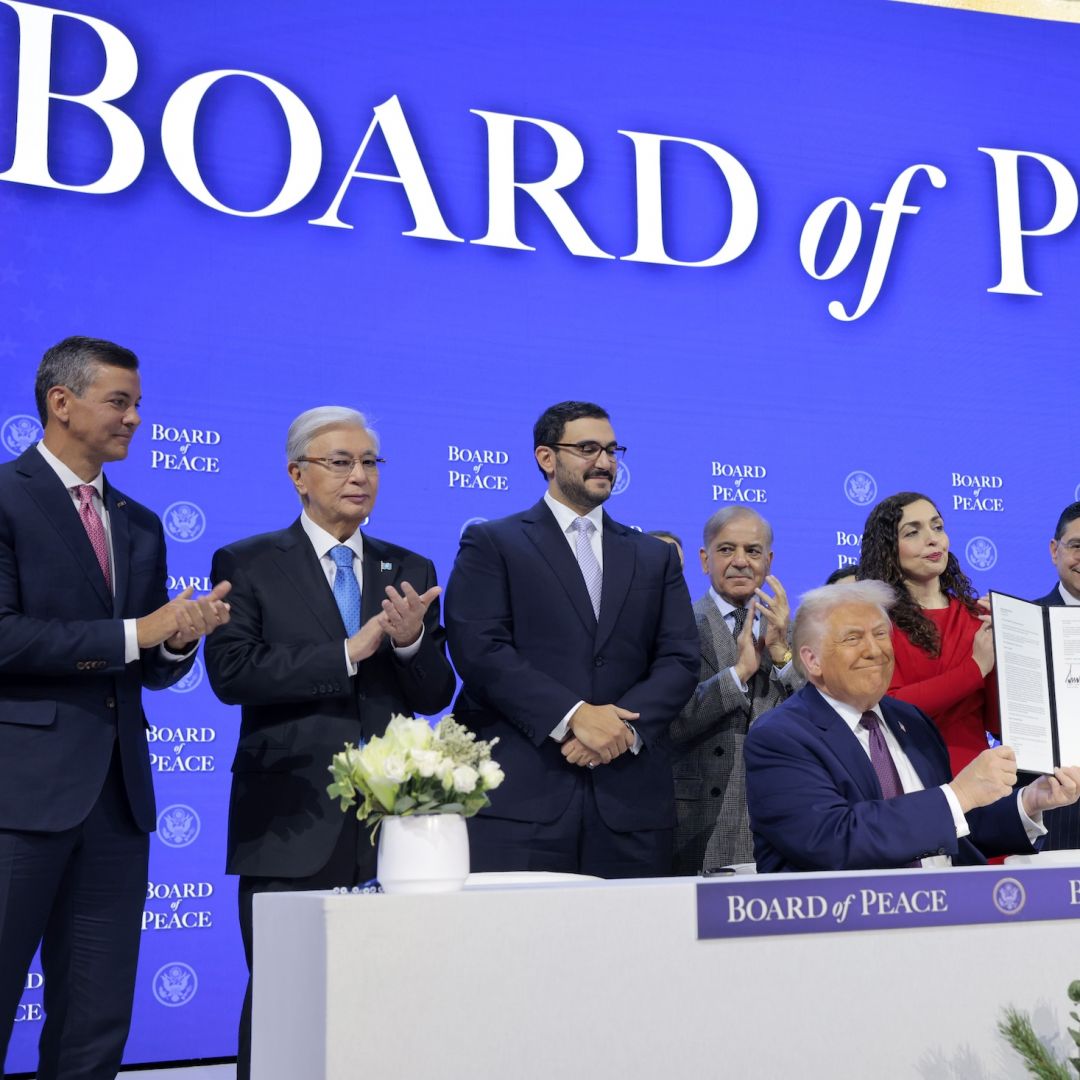 U.S. President Donald Trump (center) holds up his signature on the founding charter among world leaders during a ceremony for the Board of Peace at the World Economic Forum in Davos, Switzerland, on Jan. 22, 2026.