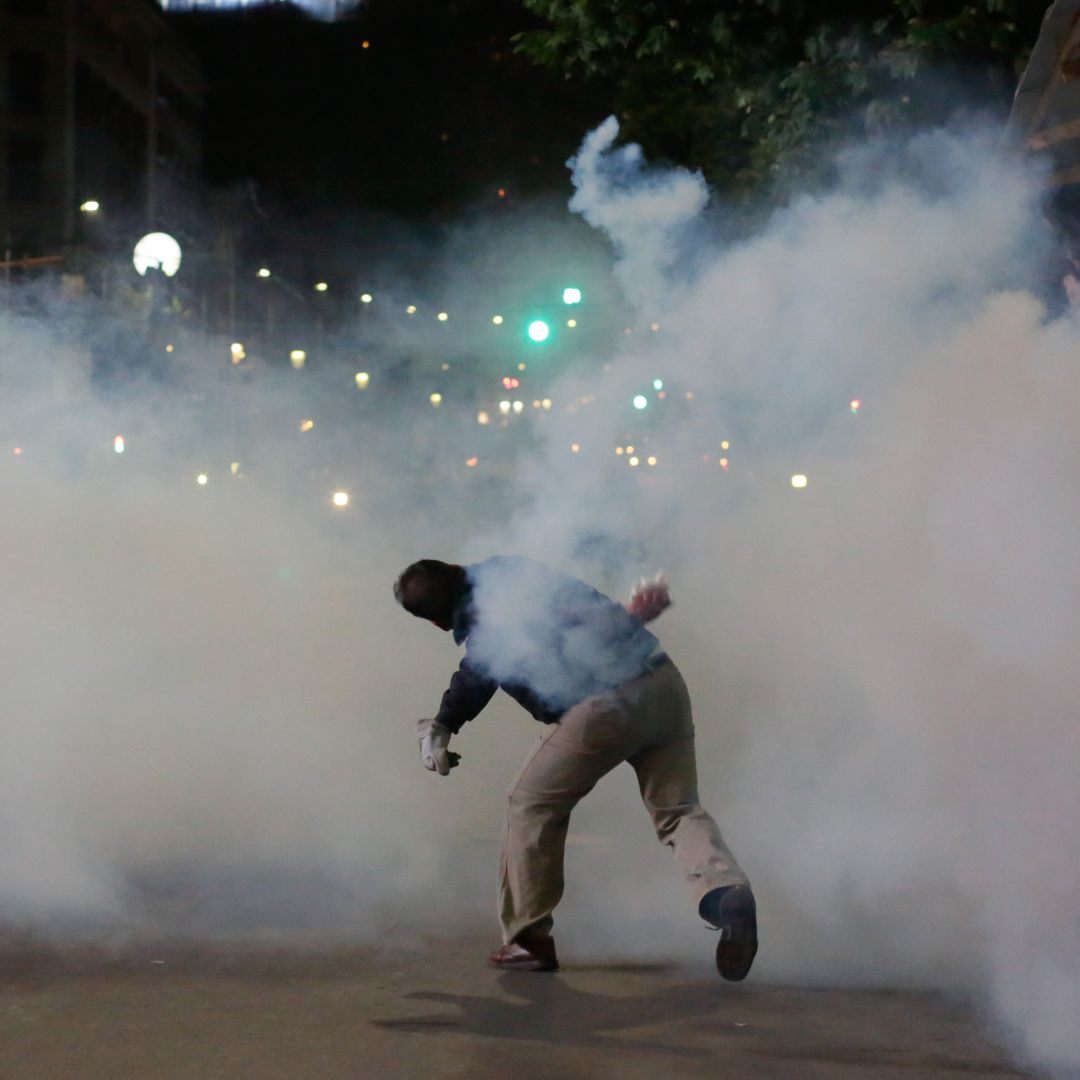 A demonstrator throws a tear gas canister during a demonstration against Bolivian President Evo Morales on Nov. 5, 2019, in La Paz, Bolivia.