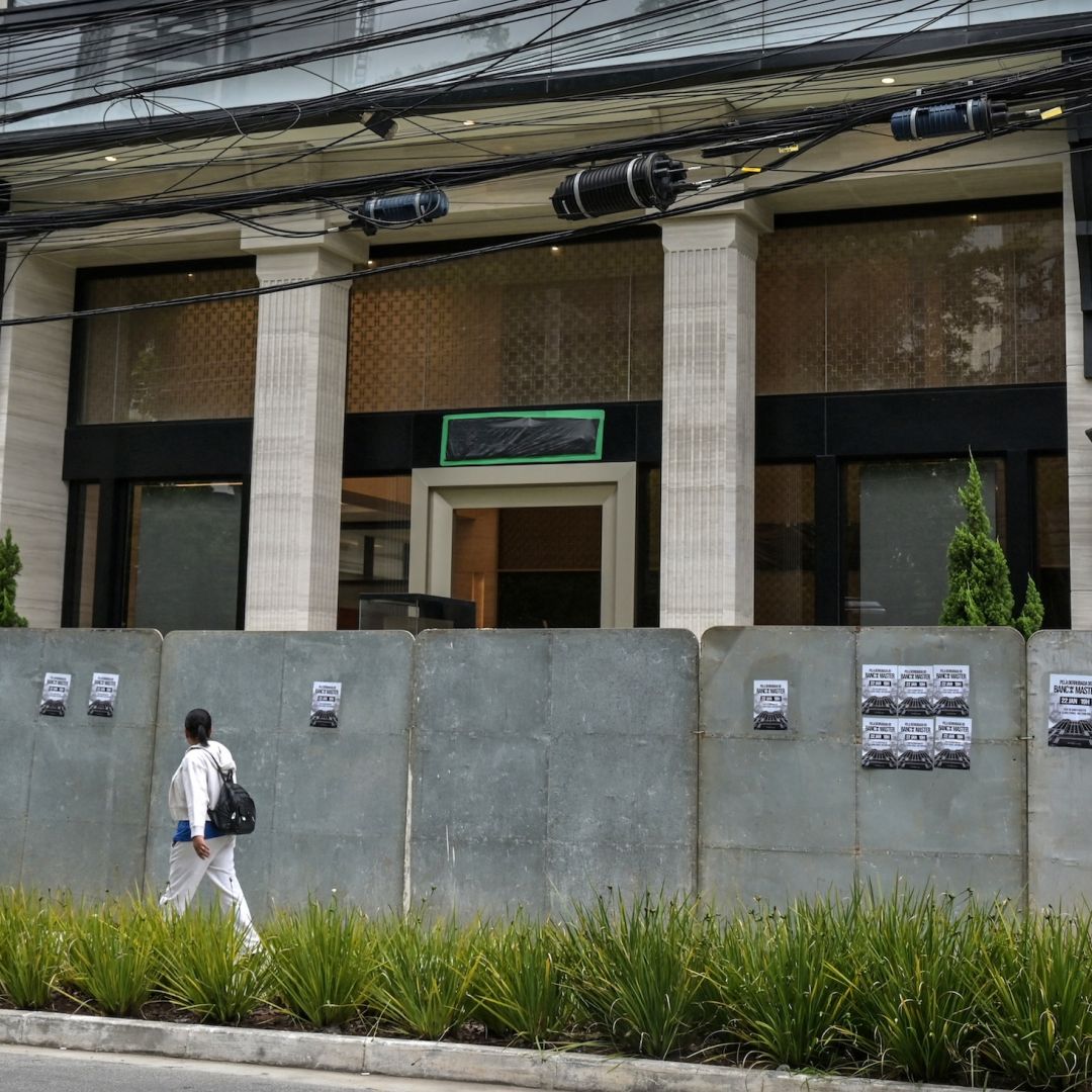 A passerby walks past the Banco Master building in Sao Paulo on Jan. 22, 2026, after Brazil's central bank ordered its shutdown due to a major liquidity crunch and "serious violations" of financial regulations.