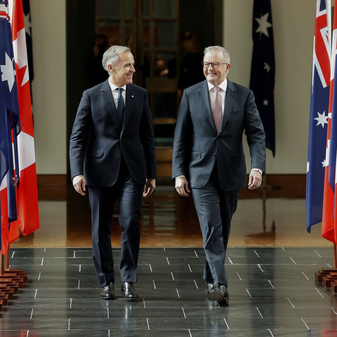 Canadian Prime Minister Mark Carney walks with Australian Prime Minister Anthony Albanese in Canberra, Australia, on March 5, 2026. 