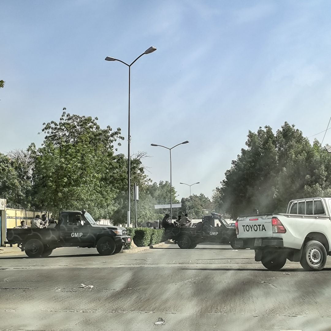 A picture taken through a car window shows Chadian soldiers barring the entrance to the road leading to the headquarters of the opposition Socialist Party Without Borders (PSF) in N'Djamena, Chad, on Feb. 29, 2024. 