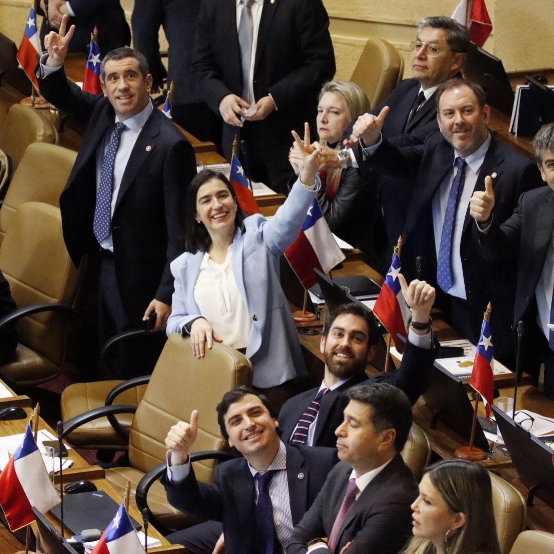 Chilean lawmakers in Congress celebrate at the end of the voting session on the economic reform bill on July 21, 2026.