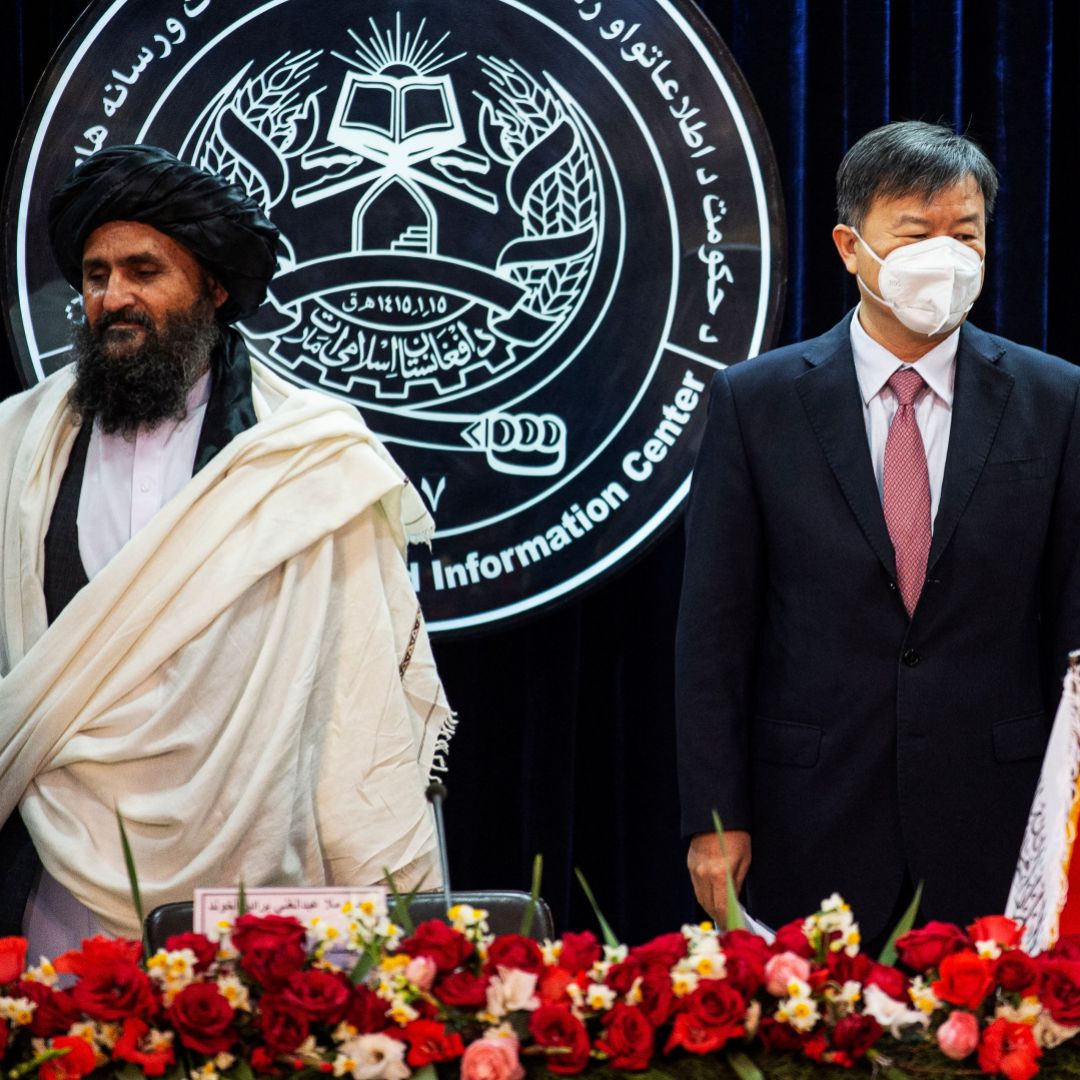 Afghanistan's acting Deputy Prime Minister, Abdul Mullah Abdul Ghani Baradar, (L) and China's Ambassador to Afghanistan, Wang Yu, (R) attend a press conference to announce an oil extraction contract with a Chinese company in Kabul, Afghanistan, on Jan. 5, 2023.