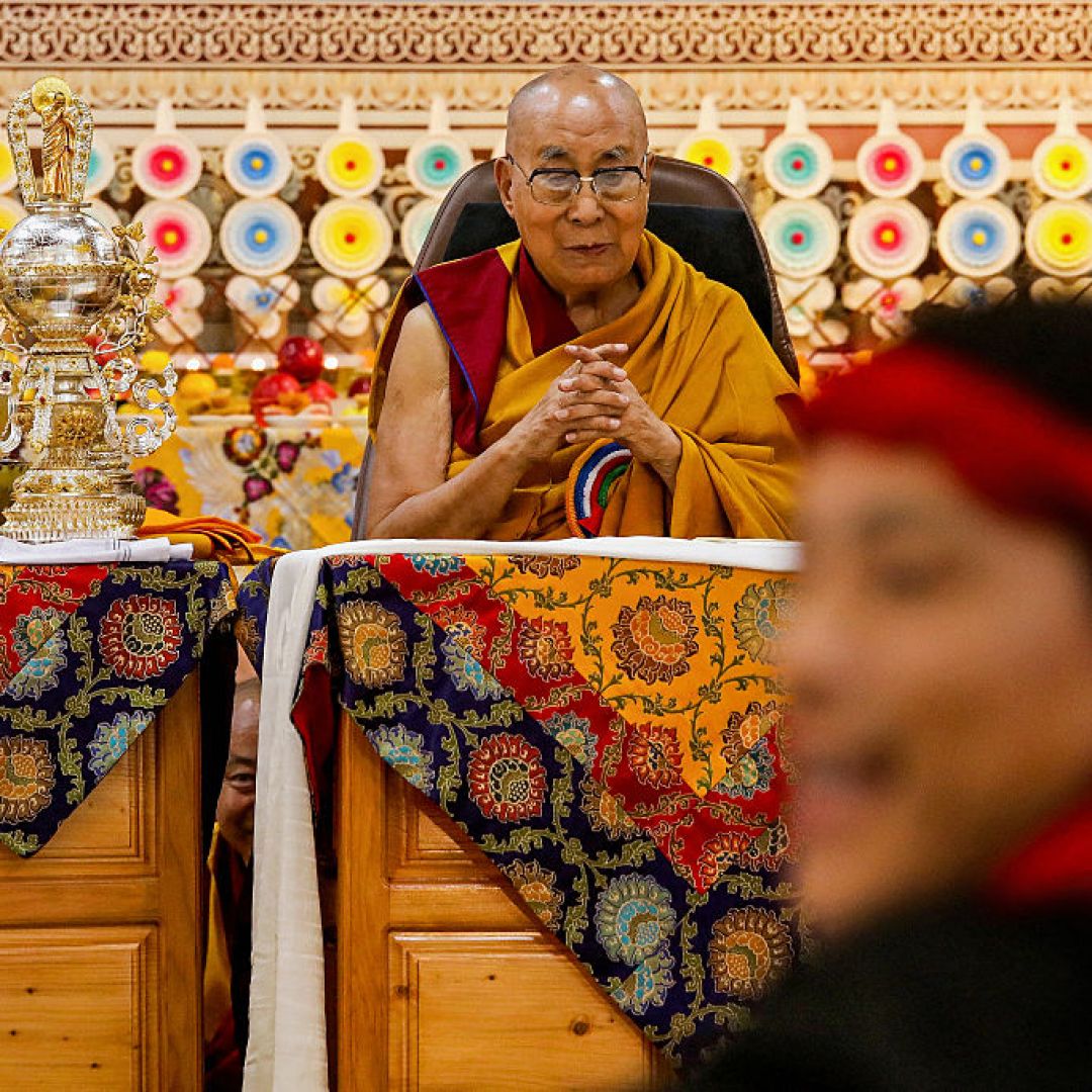 Tibetan spiritual leader the Dalai Lama looks on as offerings presented by Buddhist followers are laid on a table during a Long Life Prayer offering ceremony at the Main Tibetan Temple in McLeod Ganj, near the Indian city of Dharamshala, on June 30, 2025. 