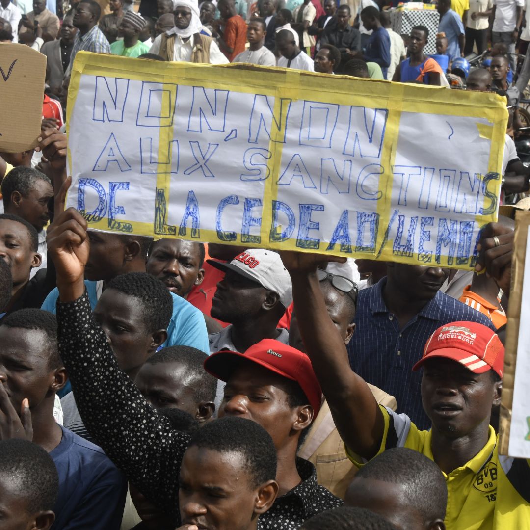 Protesters hold placards denouncing ECOWAS on Aug. 3, 2023, in Niamey, Niger.