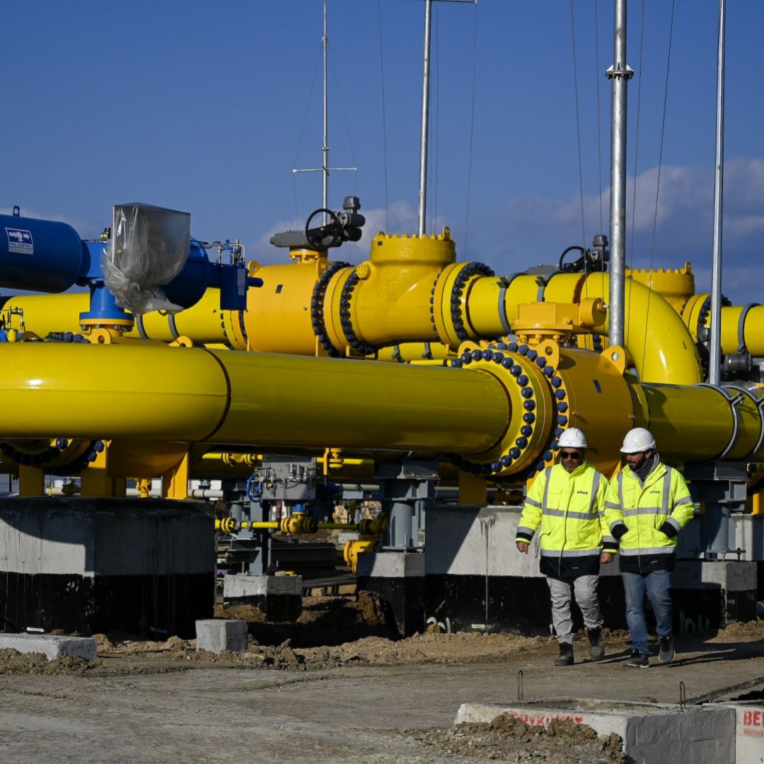 Employees walk at the construction site of a gas metering station, part of the pipeline link between Bulgaria and Greece near the village of Malko Kadievo, on March 18, 2022. 