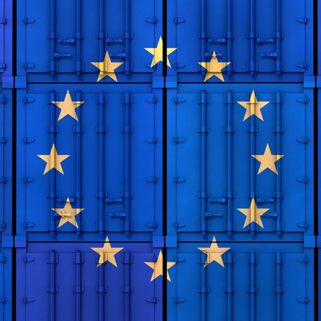 The EU flag is seen on stacked cargo containers. The EU flag is seen on stacked cargo containers.