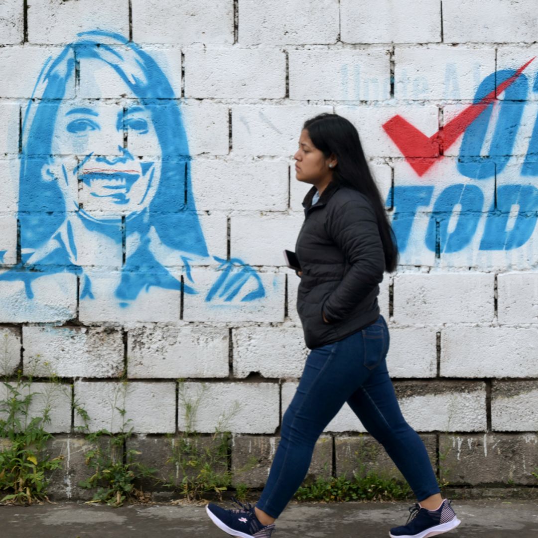 A woman walks past a mural of leftist presidential candidate Luisa Gonzalez in Quito, Ecuador, on Feb. 5, 2025.