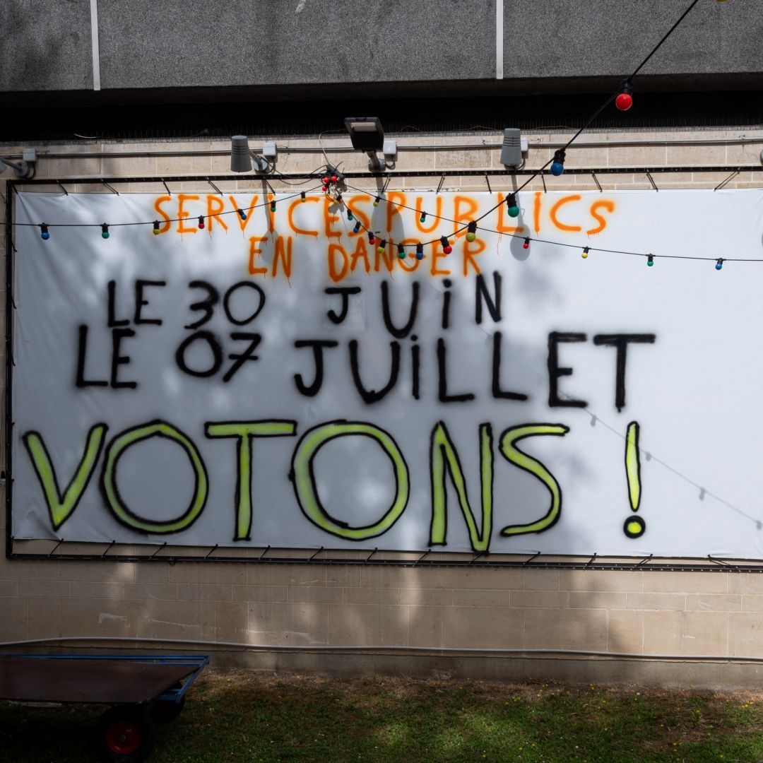 A banner reading "public services in danger, let's vote" on July 5 in Paris.