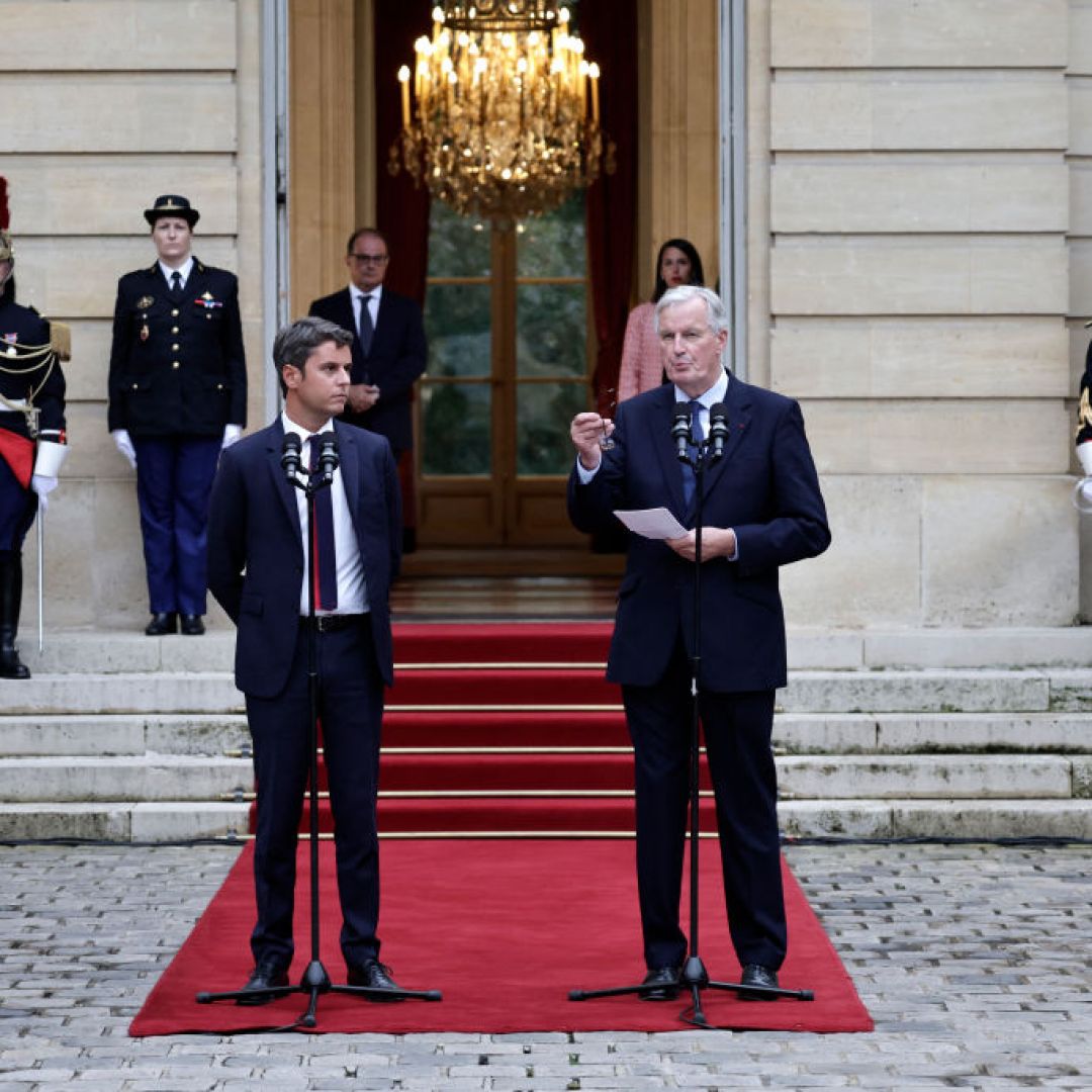 Incoming Prime Minister Michel Barnier (R) delivers a speech next to outgoing Prime Minister Gabriel Attal on Sept. 5 in Paris.