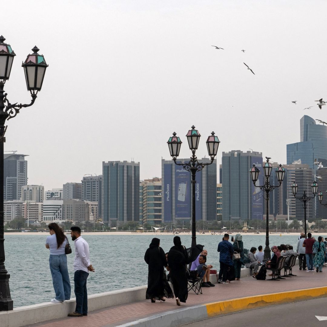 People walk along the corniche area on the occasion of Eid al-Fitr, marking the end of the holy month of Ramadan, in Abu Dhabi on March 20, 2026.