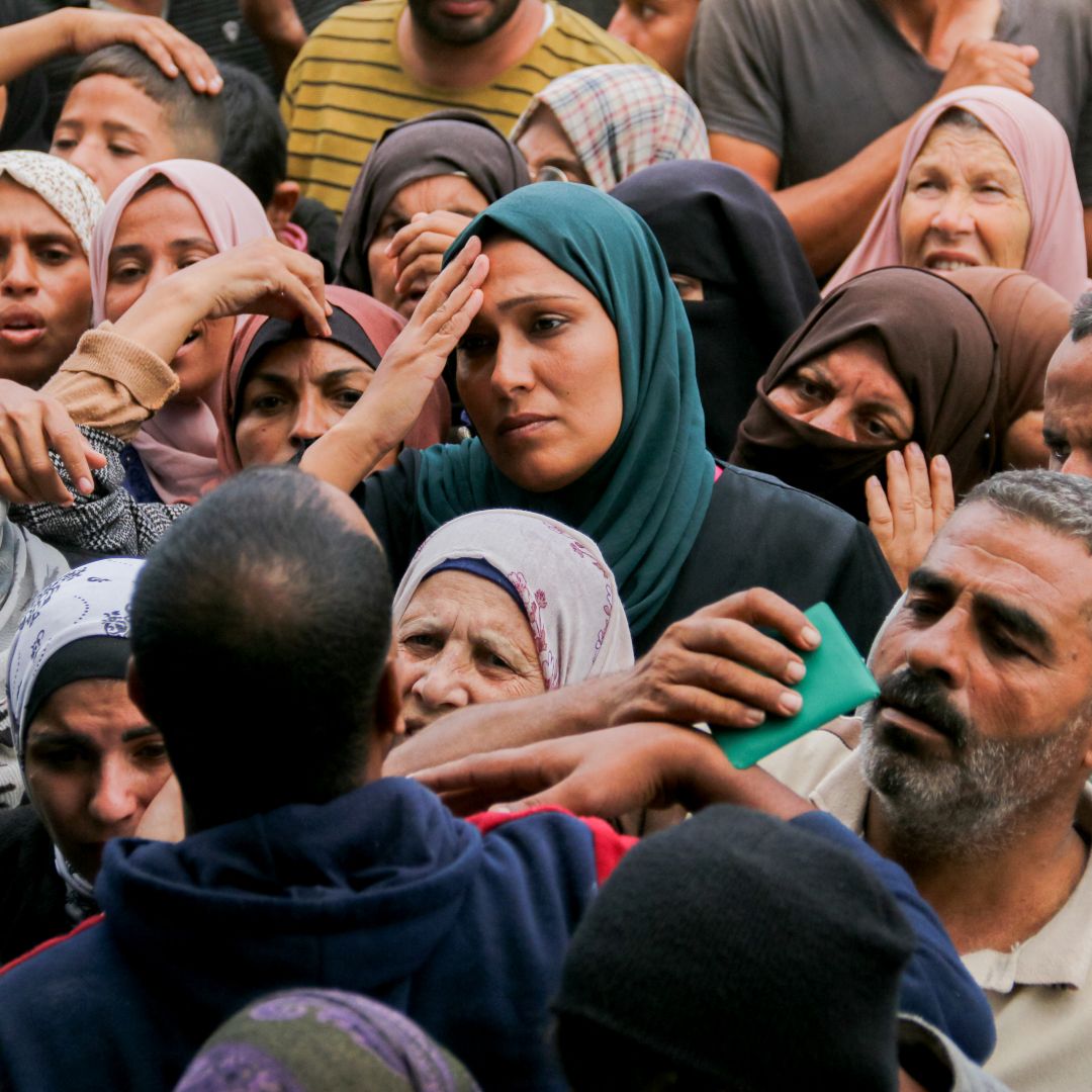 Crowds of Palestinians gather to receive food outside a U.N. aid distribution center in the Gazan city of Deir al-Balah on Nov. 2, 2024.