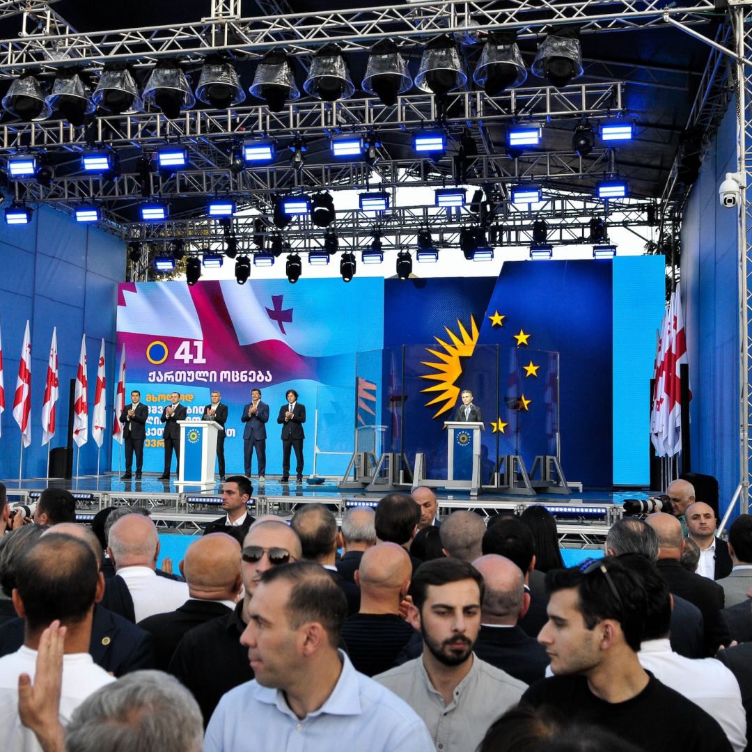 The founder of the Georgian Dream party, Bidzina Ivanishvili, stands behind the bulletproof glass as he gives a campaign speech in Gori, Georgia, on Sept. 14, 2024.