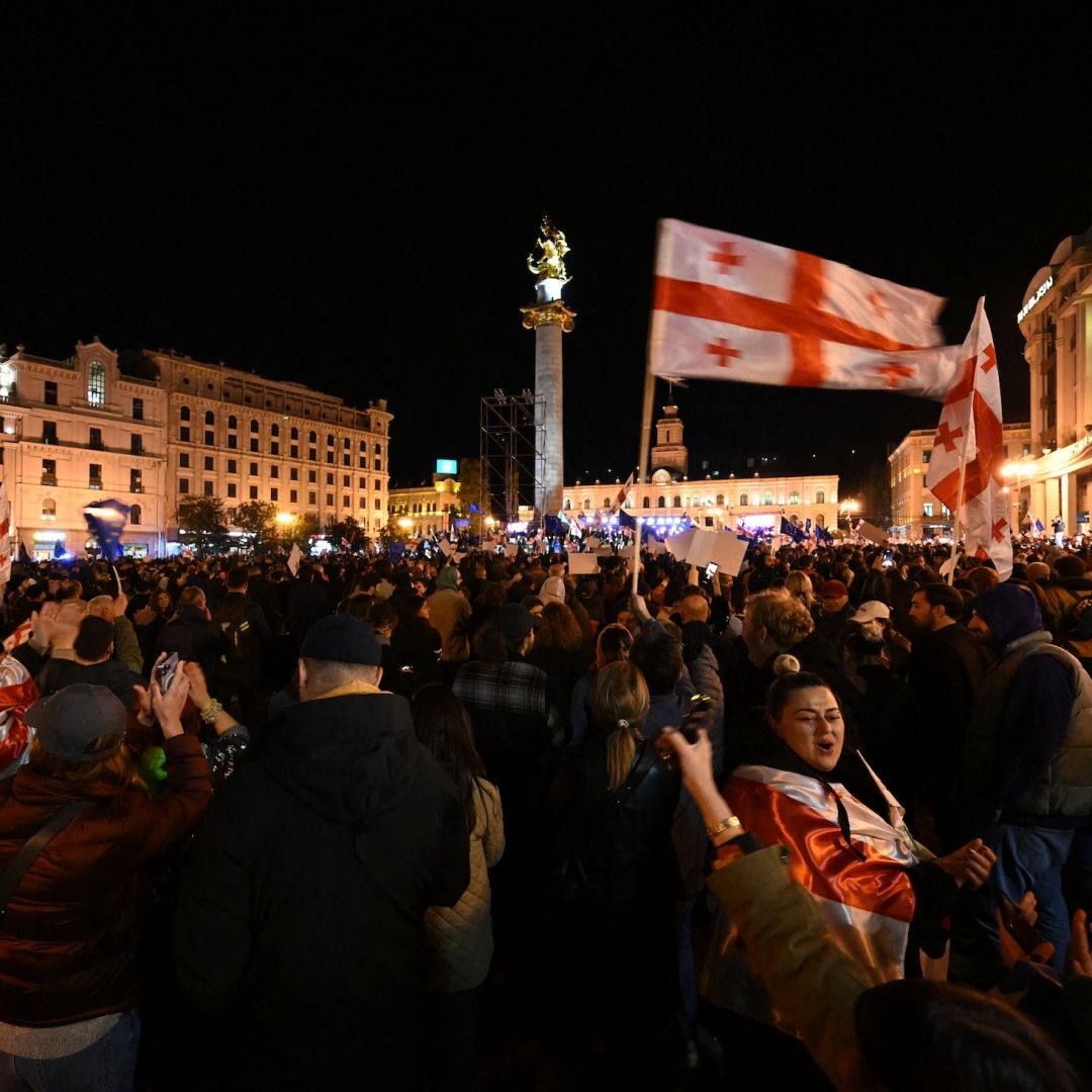 Protesters hold Georgian flags during a pro-Europe rally in Tbilisi ahead of Georgia's parliamentary elections on Oct. 20, 2024. 