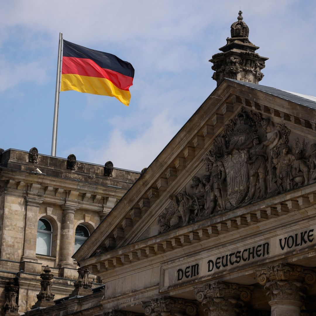 A German flag flies above the Reichstag, the building that houses the Bundestag, on July 23, 2022, in Berlin. 