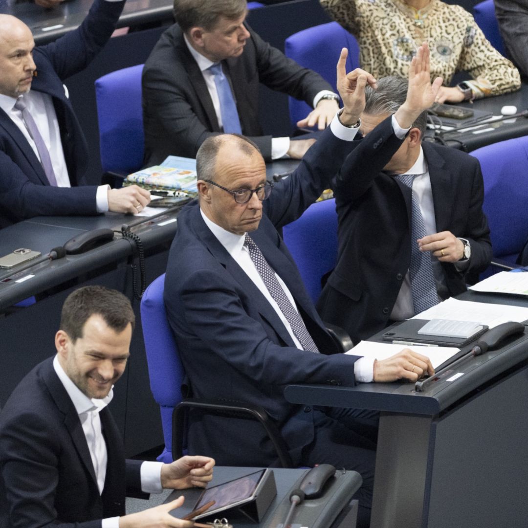 Chancellor Friedrich Merz raises his hand in a vote at the Bundestag prior to a vote on changes to Germany's Basic Law on March 18, 2025 in Berlin, Germany.  Chancellor Friedrich Merz raises his hand in a vote at the Bundestag prior to a vote on changes to Germany's Basic Law on March 18, 2025 in Berlin, Germany.