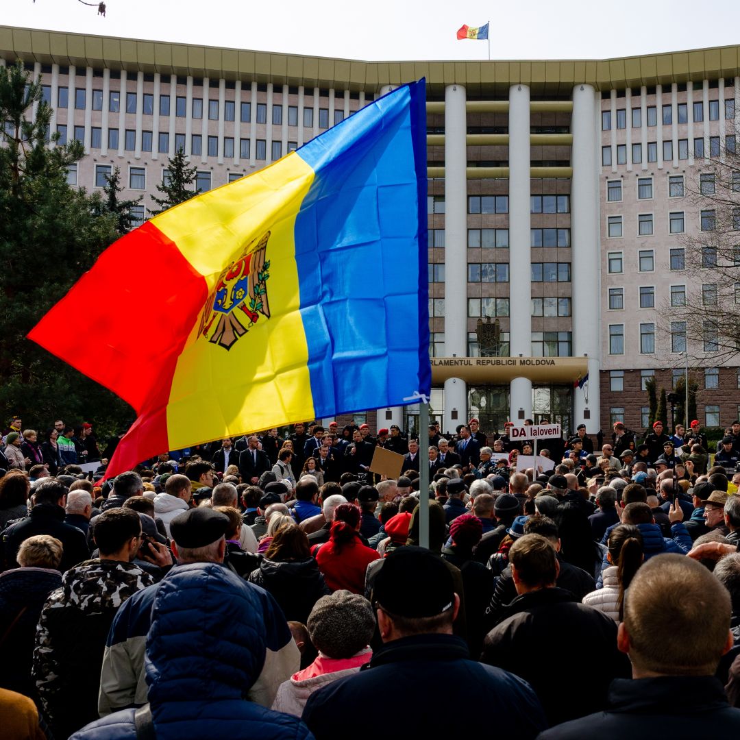 People gather outside the Moldovan parliament during a rally by the pro-European opposition ACUM bloc to protest against parliamentary election results from February.