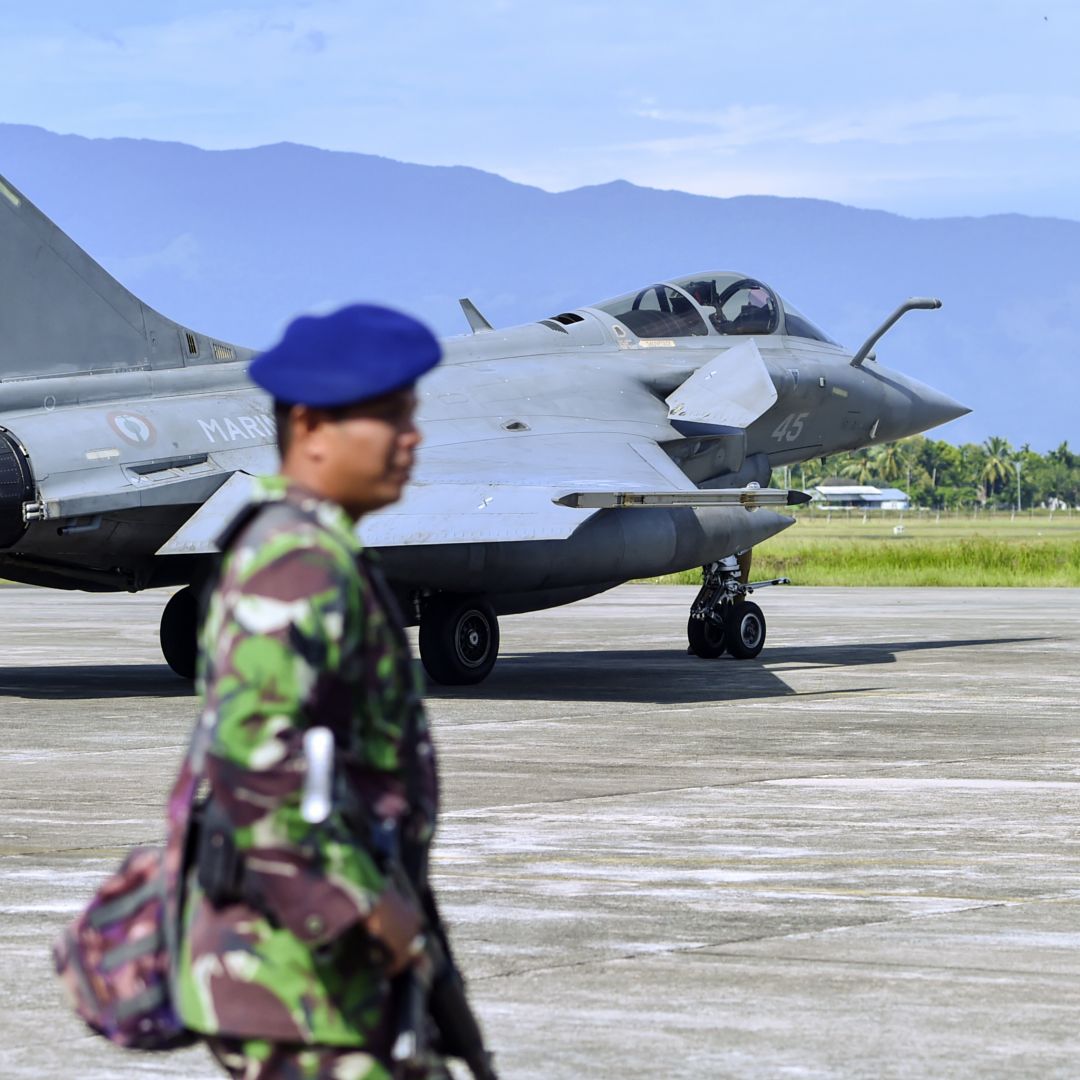 Indonesian soldiers stand guard near a French Rafale fighter jet at a military base in Blang Bintang, Indonesia, on May 19, 2019.