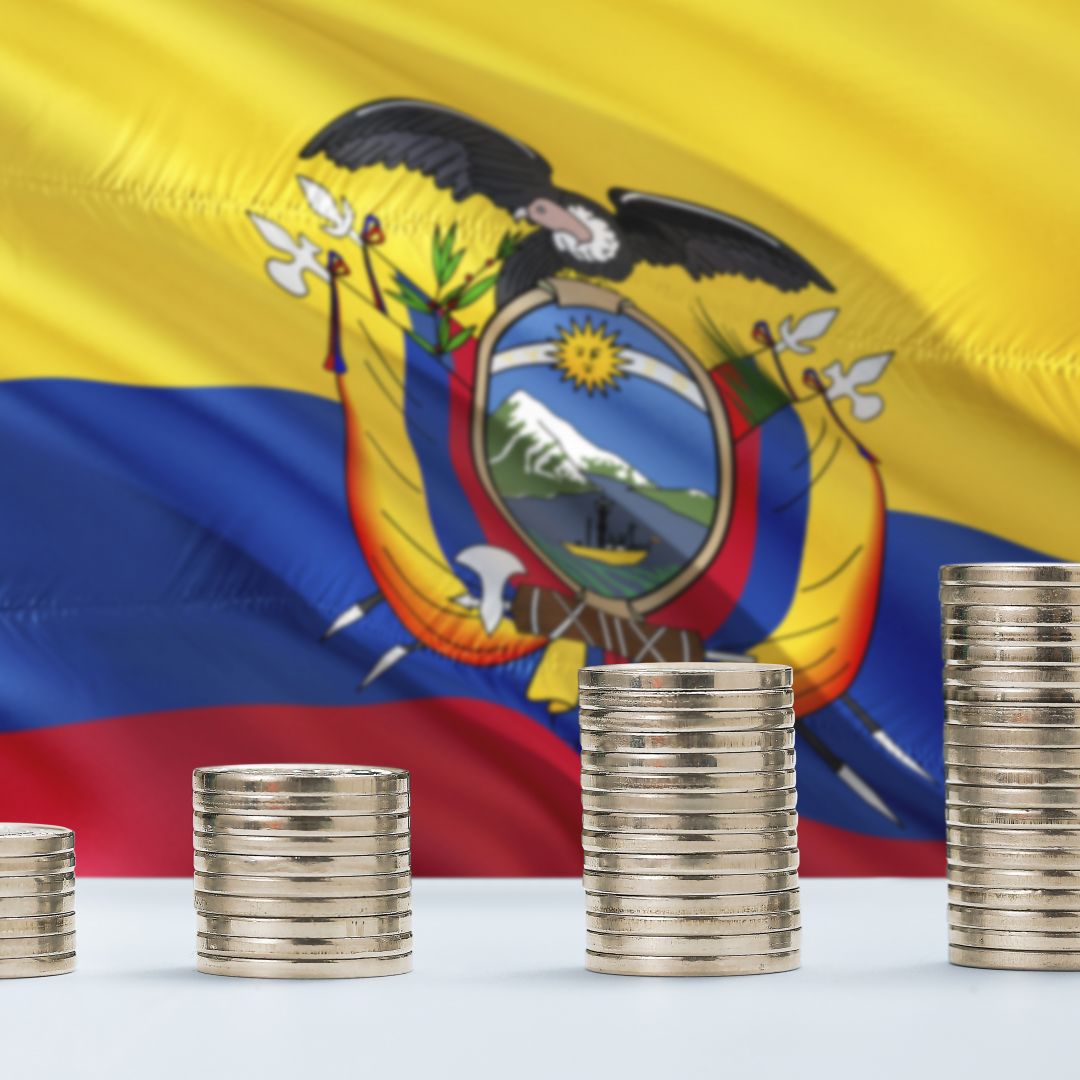 Ecuador's flag waves behind rows of coins.