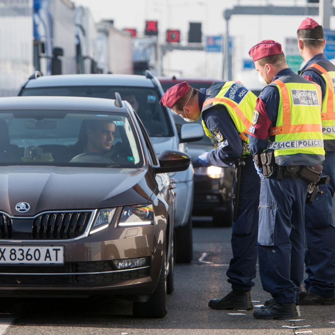 Hungarian police officers check cars at the Nickelsdorf-Hegyeshalom border crossing on the Austrian-Hungarian border on March 18, 2020. 