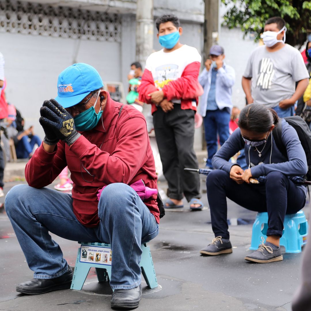 Peruvians wearing masks to protect themselves from COVID-19 wait outside a bank to collect government aid bonuses in Iquitos, Peru, on June 15, 2020. Peruvians wearing masks to protect themselves from COVID-19 wait outside a bank to collect government aid bonuses in Iquitos, Peru, on June 15, 2020.