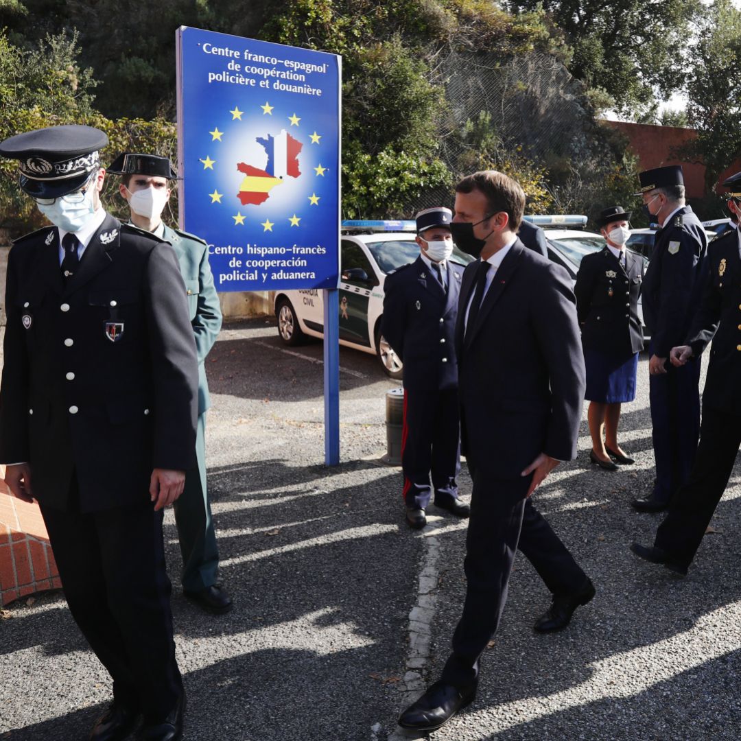 French President Emmanuel Macron (center) arrives at the Spanish border in Le Perthus, France, after he announced that the number of border guards would be doubled to 4,800 from 2,400 "because of the worsening of the threat" from terrorism on Nov. 5, 2020.