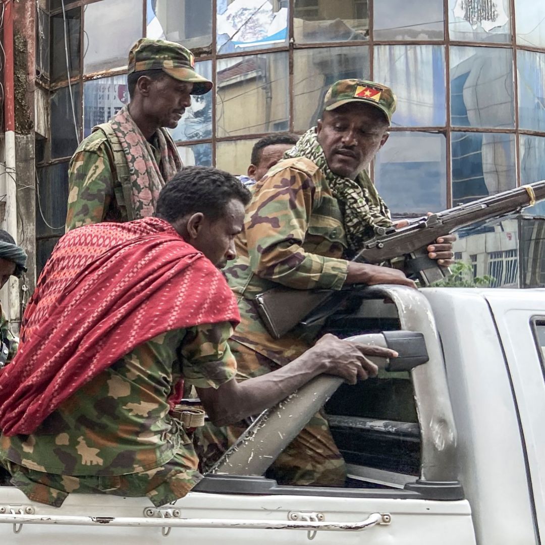 Members of the Amhara militia fighting alongside Ethiopian forces in Tigray ride on the back of a truck in Gondar, Ethiopia, on Nov. 8, 2020. 