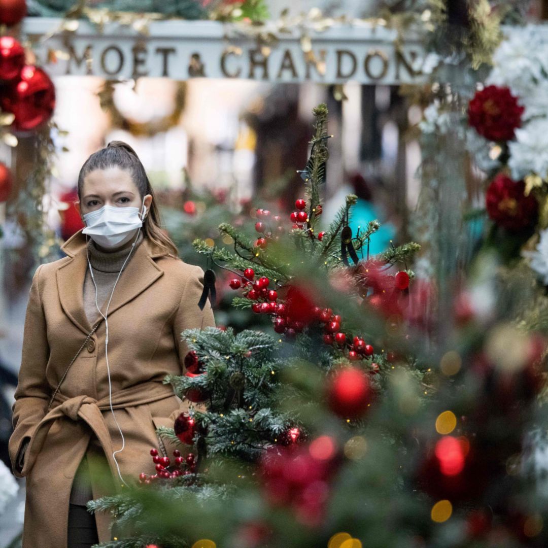 A pedestrian wearing a face mask walks past Christmas-themed window displays inside Burlington Arcade in London, the United Kingdom, on Nov. 23, 2020.