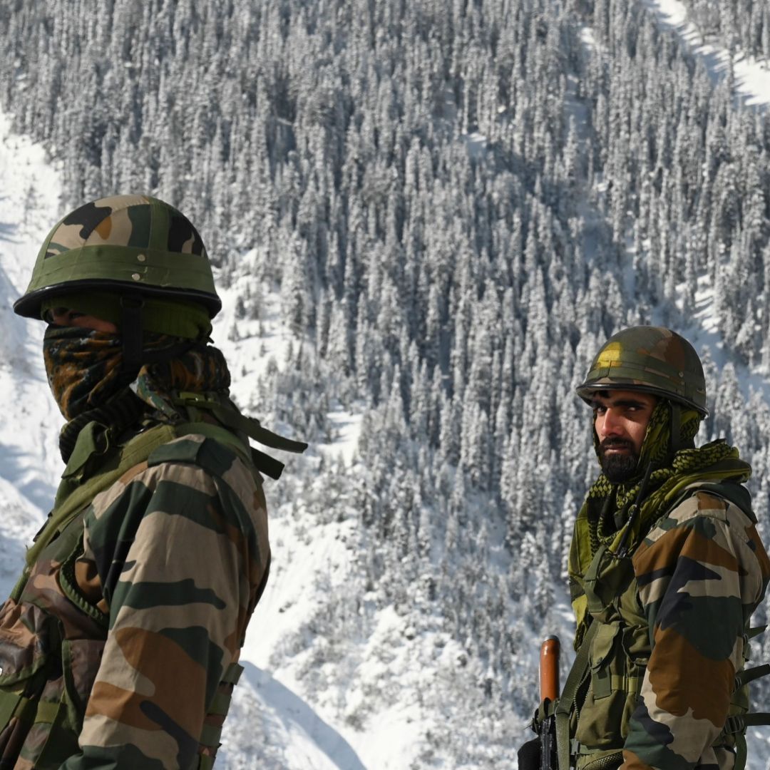 Indian soldiers walk along a road near the Zojila mountain pass that connects to Ladakh, bordering China, on Feb. 28, 2021. 