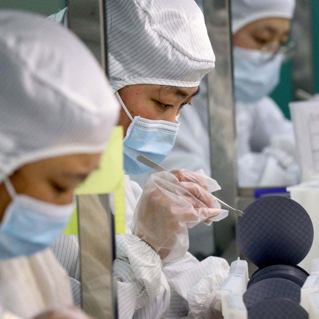 Employees make chips at a semiconductor factory in China's eastern Jiangsu province on March 17, 2021. Employees make chips at a semiconductor factory in China's eastern Jiangsu province on March 17, 2021.